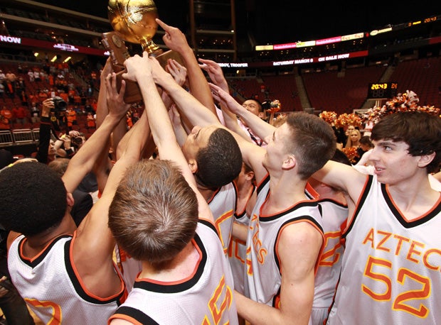 Corona del Sol collectively holds up a third-straight Arizona state Division I trophy following a heart-stopping 71-70 overtime win over Pinnacle Saturday at Jobing.com Arena.