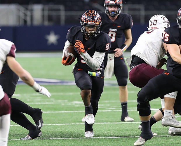 Aledo freshman running back Jase McClellen breaks through a hole.