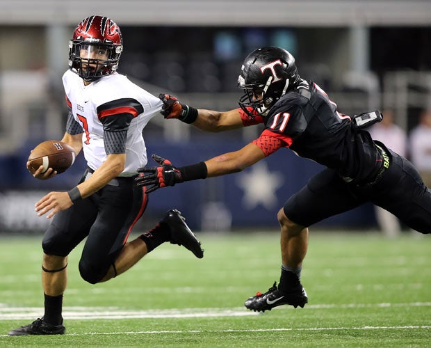 Rockwall-Heath (Texas) quarterback Jordan Hoy attempts to elude the grasp of a Trinity defender in a game played at AT&T Stadium in Arlington.