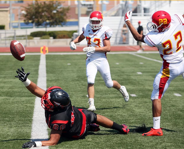 Norte Vista (Calif.) tight end Chris Rubio makes a diving attempt to catch a touchdown between two Palm Desert defenders.