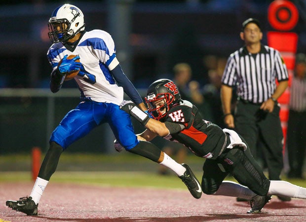 Irvington (N.J.) receiver Derrick Rivera drags West Essex cornerback Luke Magliaro into the end zone while scoring a touchdown.