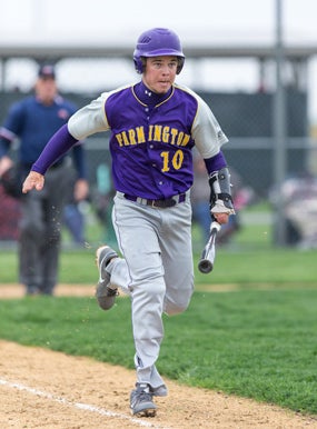 Josh Ruchotzke carries his bat with him to firstbase because it requires effort to release the batfrom the apparatus on his arm.