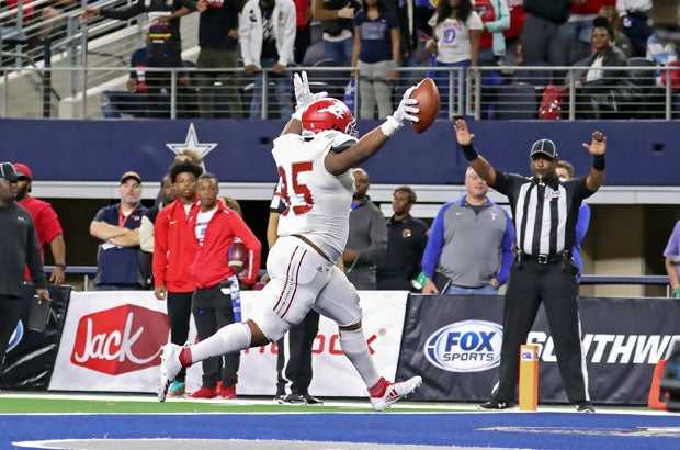 Jordan Revels (95) hauls in Davis' fourth TD pass on a tackle eligible play midway through fourth quarter.