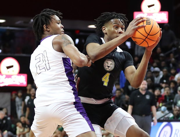 D.J. Wagner (left) went one-on-one against Simeon Wilcher (right) most of the game Sunday in Roselle Catholic's 61-58 overtime win. 