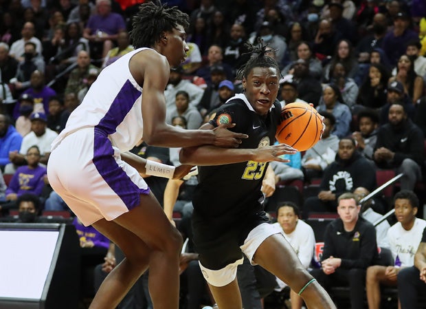 Akil Watson (23) drives toward the hoop for Roselle Catholic.
