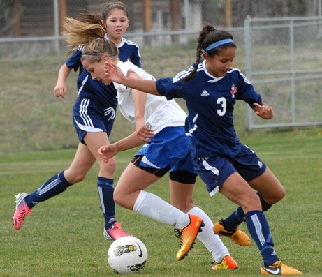 Senior Paige Ryan (white jersey), with 24 goals, leads a high-powered offense for undefeated Coal Ridge. Ryan also is a standout on the track team along with eight other Titans players.