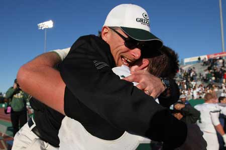 Coach Ernie Cooper celebrates his first Division 1 section title with bear hug from lineman Gavin Andrews.