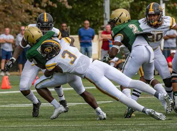 St. Frances Academy's Demon Clowney (3) with a big tackle in the backfield.