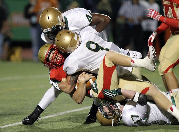 Dominic Carfagno (9) and Joseph Giles-Harris (44) personified a hard-hitting defense in St. Joseph Regional's 49-6 win over Bergen Catholic on Saturday.