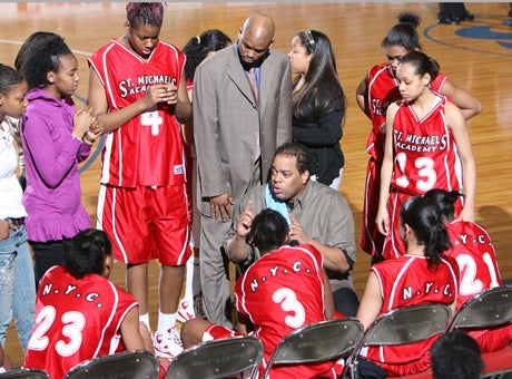 Apache Paschall (center) of St. Michael's Academy is the coach of the year.