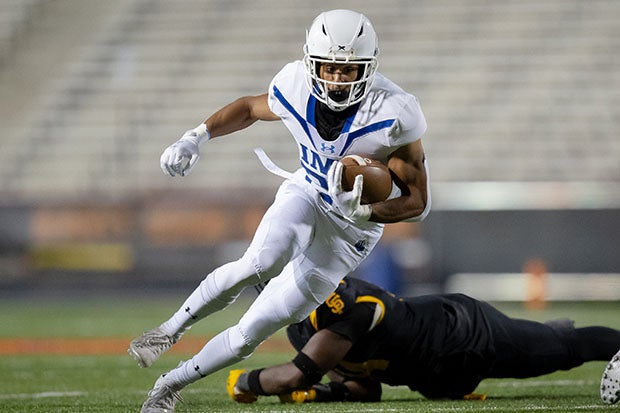 IMG Academy senior running back Evan Dickens evades a defender during his team's win Friday night on the campus of University of Maryland. (Photo: Cory Royster)