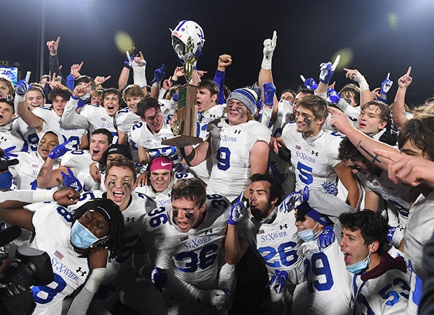 St. Xavier players proudly display the championship trophy.