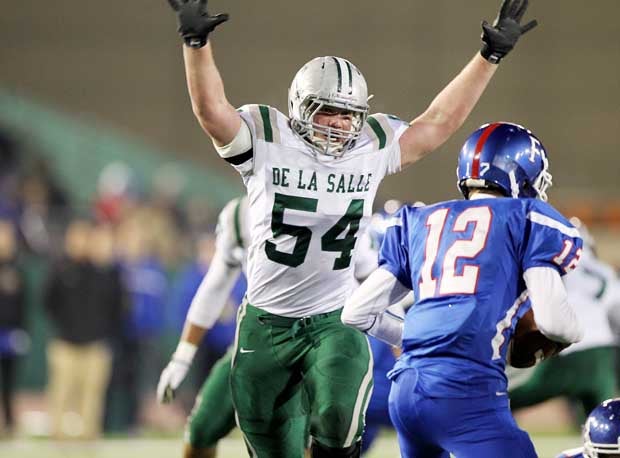 Sumner Houston (54) tries to put a scare into Folsom quarterback Jake Browning in last year's 49-15 De La Salle victory in the Northern California Open Division Regional Bowl final at Sacramento State. The two teams rematch at Diablo Valley College in Pleasant Hill on Saturday and Houston and Browning should be key components.