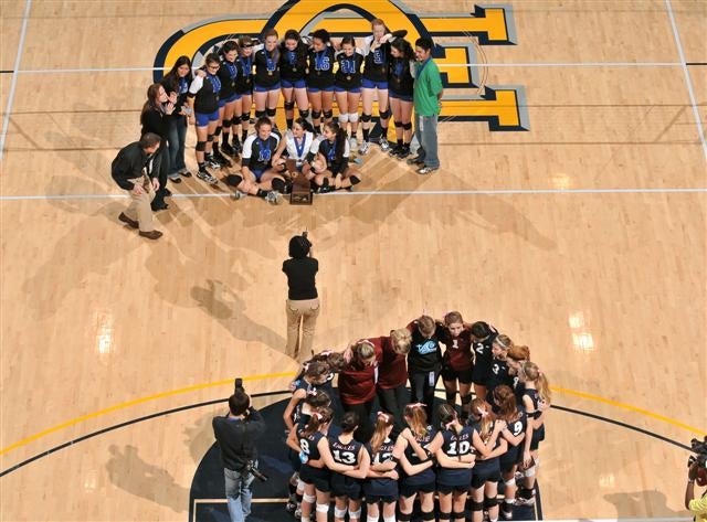 Branson poses for championship picture while Tri-City Christian gathers close to celebrate triumphant season.