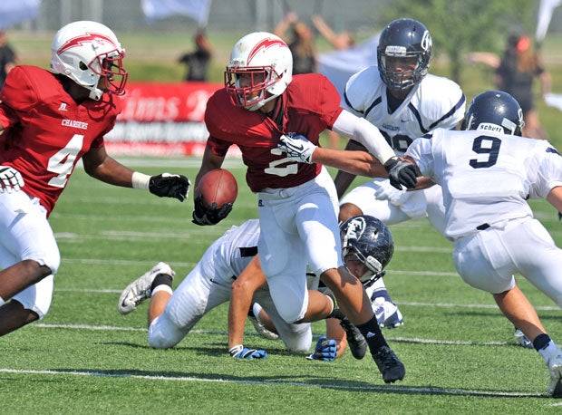 Justin Manuatu of Keller Central (Texas) gets grabbed by a Flower Mound (texas) would-be tackler.