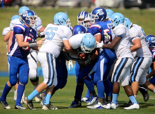 A ballcarrier for Boone County (Florence, Ky.) gets hoisted by a crowd of defenders from Conner (Hebron, Ky.) at the Crosstown Showdown.