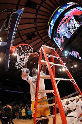 A Montverde Academy player cuts down the nets at Madison Square Garden.