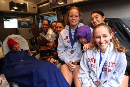 University celebrates in the ambulance with Holland. 