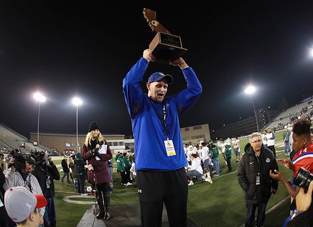 Folsom coach Kris Richardson proudly hoist the state championship trophy.
