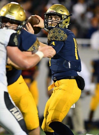 Aquinas quarterback Jake Allen drops back to pass.