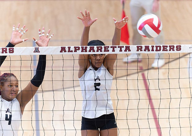 Alabama commit Audrey Simpson (left) and Kennedi White (center) of Alpharetta rise for a block during a match last month. The Raiders meet Walton  in Georgia's Class AAAAAA state championship game Thursday. (PHOTO: Darren Freeman)