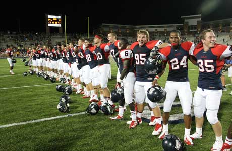 Allen players celebrate on the field following their victory over Carroll.