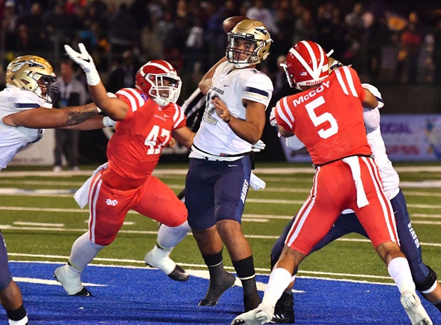 St. John Bosco sophomore quarterback DJ Uiagalelei is pressured by Kyron Ware-Hudson (42) and Bru McCoy (5).