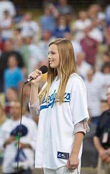 Mackenzie Luderer, granddaughter of Vin Scully, sang the national anthem at Dodger Stadium.