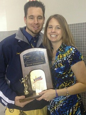 Jenica Brown with her brother Jarod, holding the
state championship trophy.