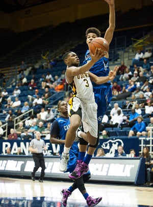 Bishop O'Dowd's Paris Austin swoops in
for a deuce in January at the MLK Classic
versus Capital Christian, the team it plays
in the NorCal Open finals after each squad
rattled off semifinal wins Tuesday.