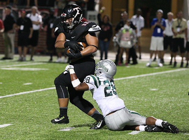 Trinity's Samuela Leota returns a fumble for a touchdown during the second quarter.