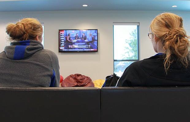 After a late-day study session, the twins often take a mental break and watch some television.