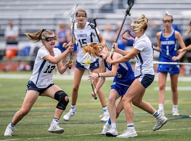 Kennebunk junior Ruby Sliwkowski hangs on to the ball despite a hit to the chin during the 11-6 victory over Yarmouth. Sliwkowski scored six goals in the Rams' MPA Class A state finals win.