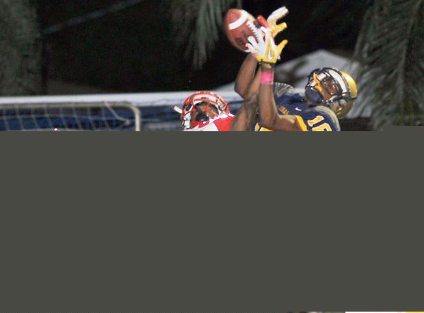 Derek Rodgers and Danta Campbell jump for a pass during the teams' matchups earlier in the decade.