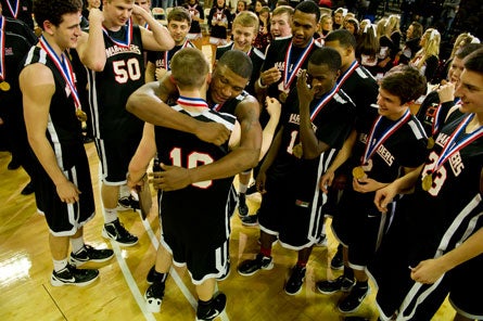 Oklahoma State-bound seniors Phil Forte (10) and Marcus Smart embrace after capping one of the great three-year runs in state history with a second state title.