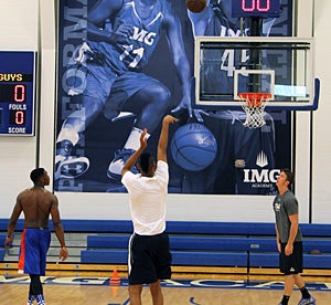 Though not declared for the NBA Draft, Florida
Gator guard Michael Frazier II looks on as Cooper
fires off a jumper during a drill.