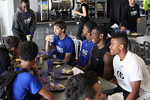 Cooper, far right, has a laugh during lunch with his
teammates.