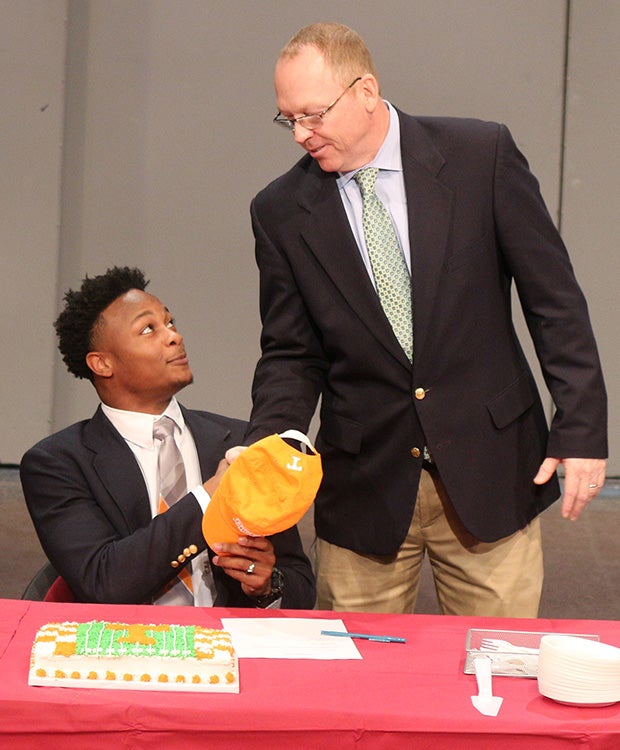 Montgomery Bell Academy (Tenn.) running back Ty Chandler is congratulated by head coach Marty Euverard after signing with Tennessee.