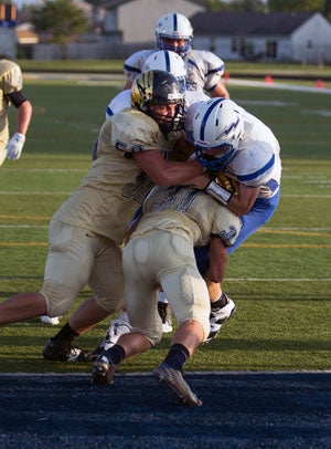 John Sidwell (50) and Austin Nelms (31) lead
the Decatur Central defense on this play.