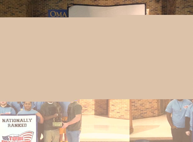 Omaha North players pose with the Minuteman Trophy.