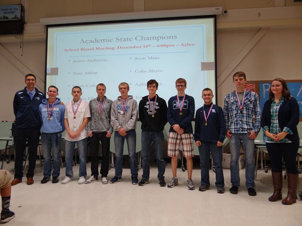 Smith, third from right, along with his Rogers cross county teammates being presented their academic state championship.