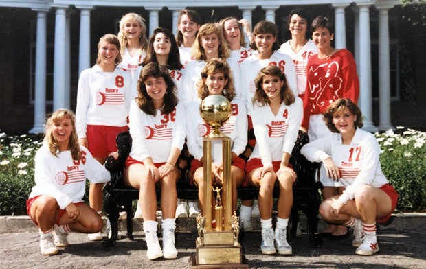 Ellen Manning (Heidingsfelder) sits in the middle front row right behind the 1986 Academy of the Sacred Heart state title trophy. To her left is Betsy Laborde (Becker) who was an assistant coach for the Cardinals in 2020. 