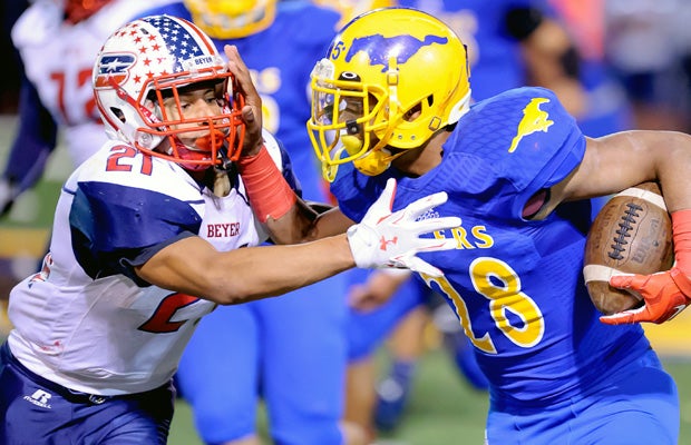 Grant running back Mike Green II attempts to elude Beyer defensive back Anthony Saliaz.