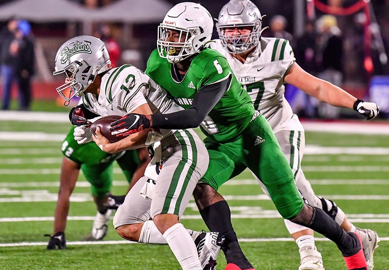 Lincoln senior Chris Fewell gets to the De La Salle quarterback in the CIF Division 1-AA finals Friday at Saddleback College in Mission Viejo. (Photo: Louis Lopez)