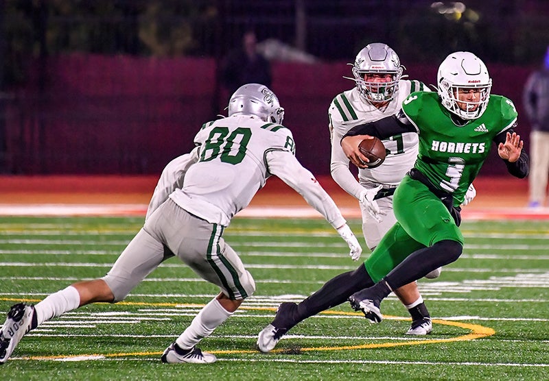 Lincoln quarterback K.J. Chatham runs with the ball in the CIF Division 1-AA finals Friday at Saddleback College in Mission Viejo. (Photo: Louis Lopez)