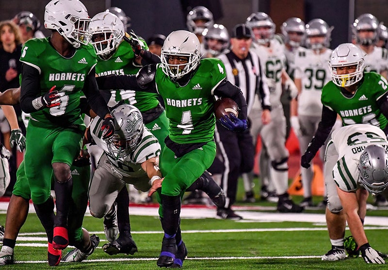 Lincoln senior Chris White gains some yards in the CIF Division 1-AA finals Friday at Saddleback College in Mission Viejo. (Photo: Louis Lopez)