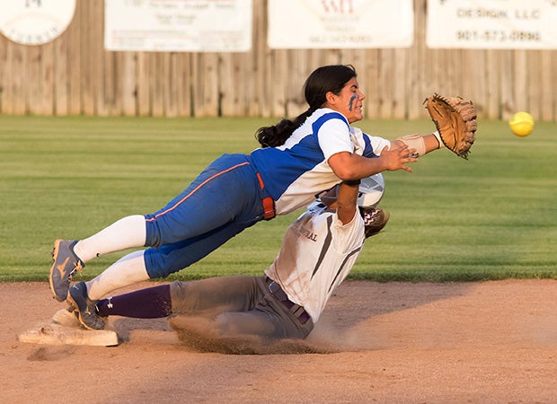 Southaven (Miss.) infielder Joanna Vasquez attempts to catch a throw from the catcher while colliding with a DeSoto Central (Southaven, Miss.) baserunner on a steal.