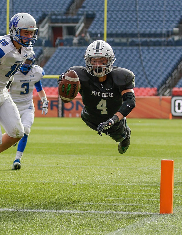 Peter Isais of Pine Creek (Colo.) dives into the end zone during the CHSAA 4A state title game against Broomfield at Sports Authority Field in Denver.