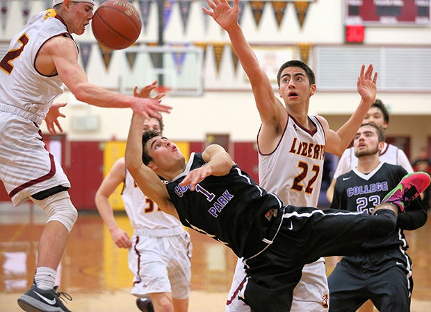 College Park (Calif.) guard Nick Lombardi attempts an off-balance shot that deflects off the face of Liberty's Carson Musgrove during a game in the Stonebarger Tournament.