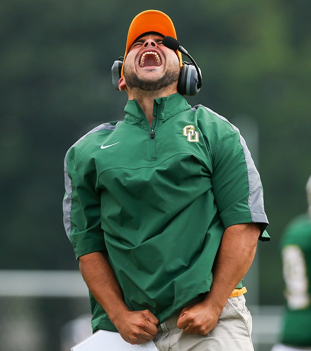 A Greece Olympia/Greece Odyssey (N.Y.) coach celebrates a touchdown during a football game against Greece Athena.